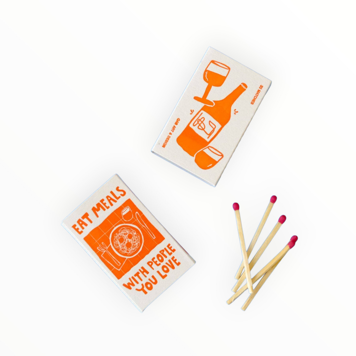 Two small matchboxes with red illustrations and text, plus several wooden matches with pink tips, arranged on a clean white background.