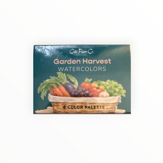A boxed watercolor palette titled 'Garden Harvest' by Cate Paper Co., featuring a teal cover with an illustration of a basket of vegetables and fruit.