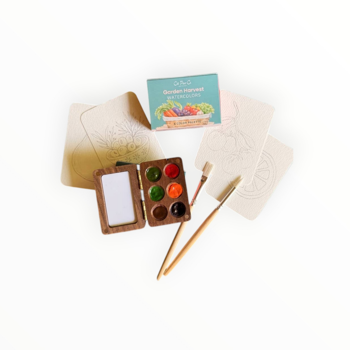Cate Paper Co. Garden Harvest wooden watercolor palette open showing six hand-poured paints with garden harvest scene outlines and two brushes