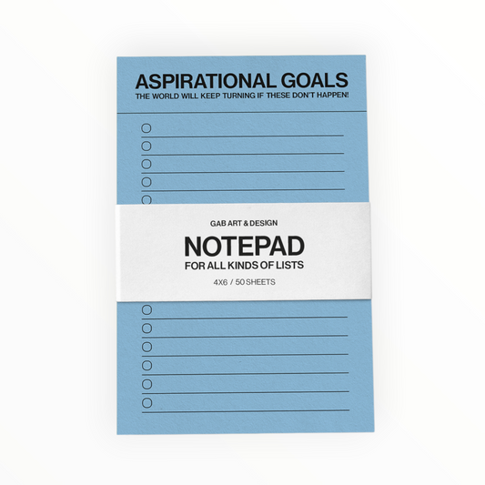 A light blue notepad with a white paper band around the center, featuring the text 'ASPIRATIONAL GOALS' at the top and 'NOTEPAD FOR ALL KINDS OF LISTS' on the band. The notepad has multiple lined list sections with circular checkboxes.