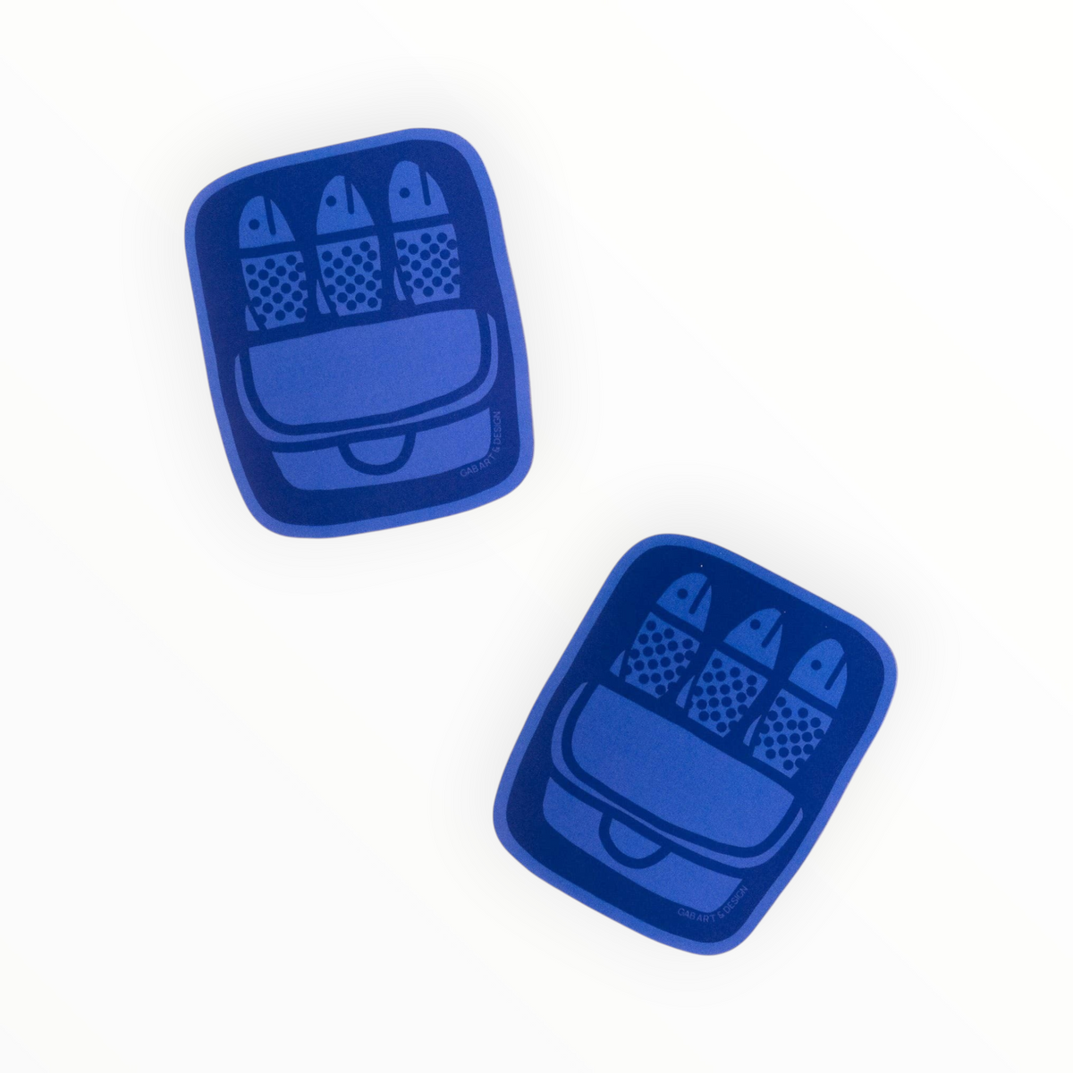 A blue rectangular adhesive sticker with rounded corners, featuring a printed graphic of three fish in a tin case