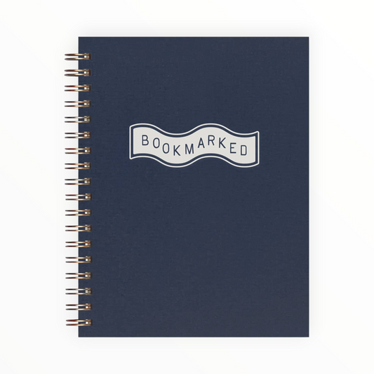 Bookmarked Book Log Reading Journal by Ruff House Print Shop, deep blue cover with white ink, gold wire-o binding, 60 pages, 6.5 x 5.25 inches, Lawrence KS